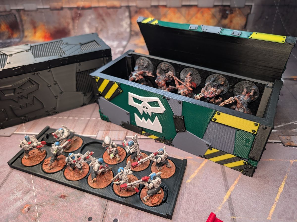 The Community Case open, with painted miniatures inside and a loaded tray in front